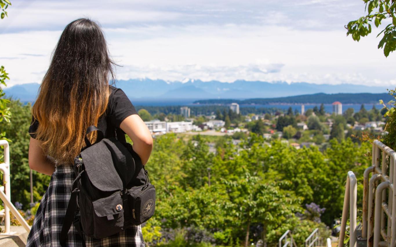 Student looks at the view wearing a backpack