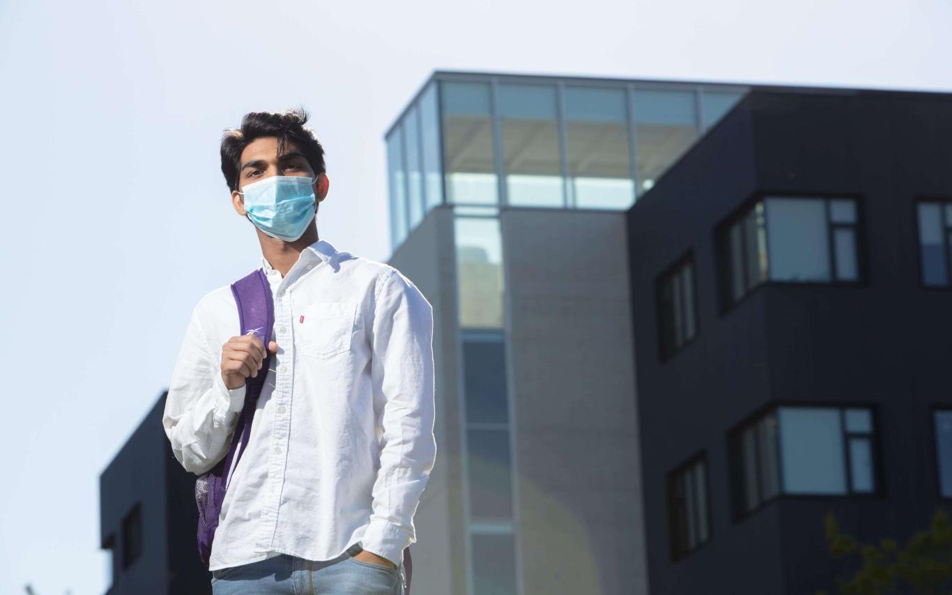 Student with backpack wearing a mask