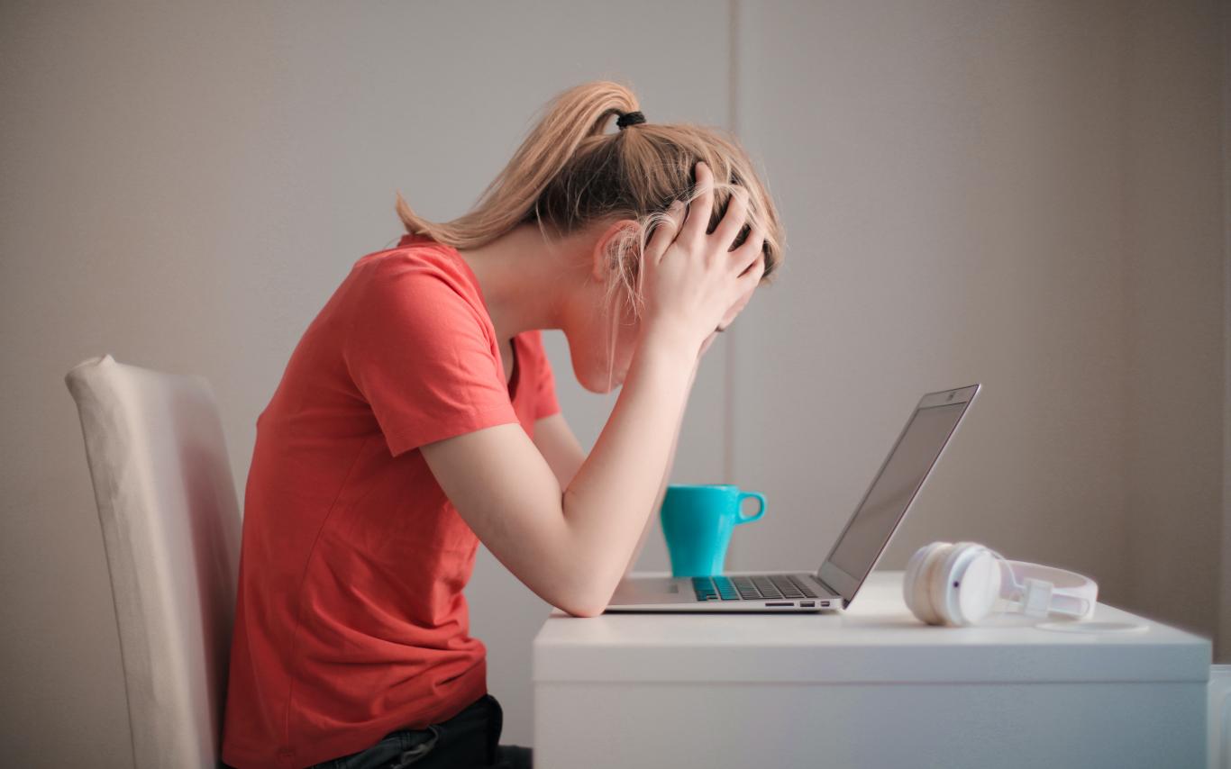 Student sitting at a desk in front of a laptop