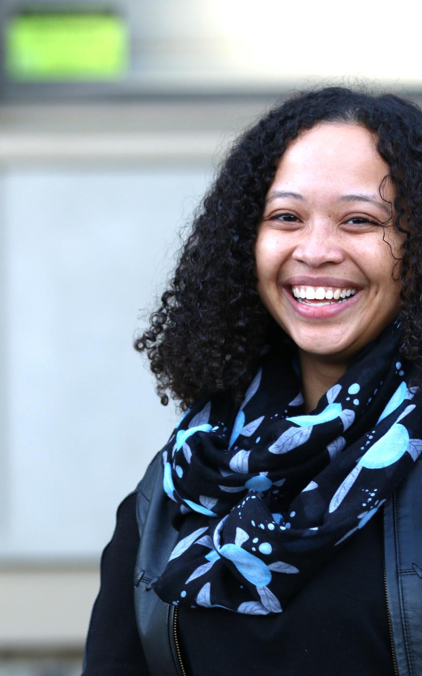 Felicia Fischer in front of the Master of Community Planning program building