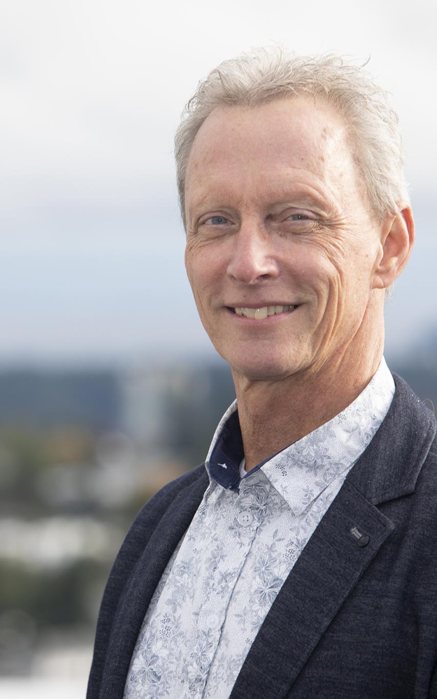 VIU Educational Advisor Michael Kuntz stands in front of a beautiful clear blue skyline.