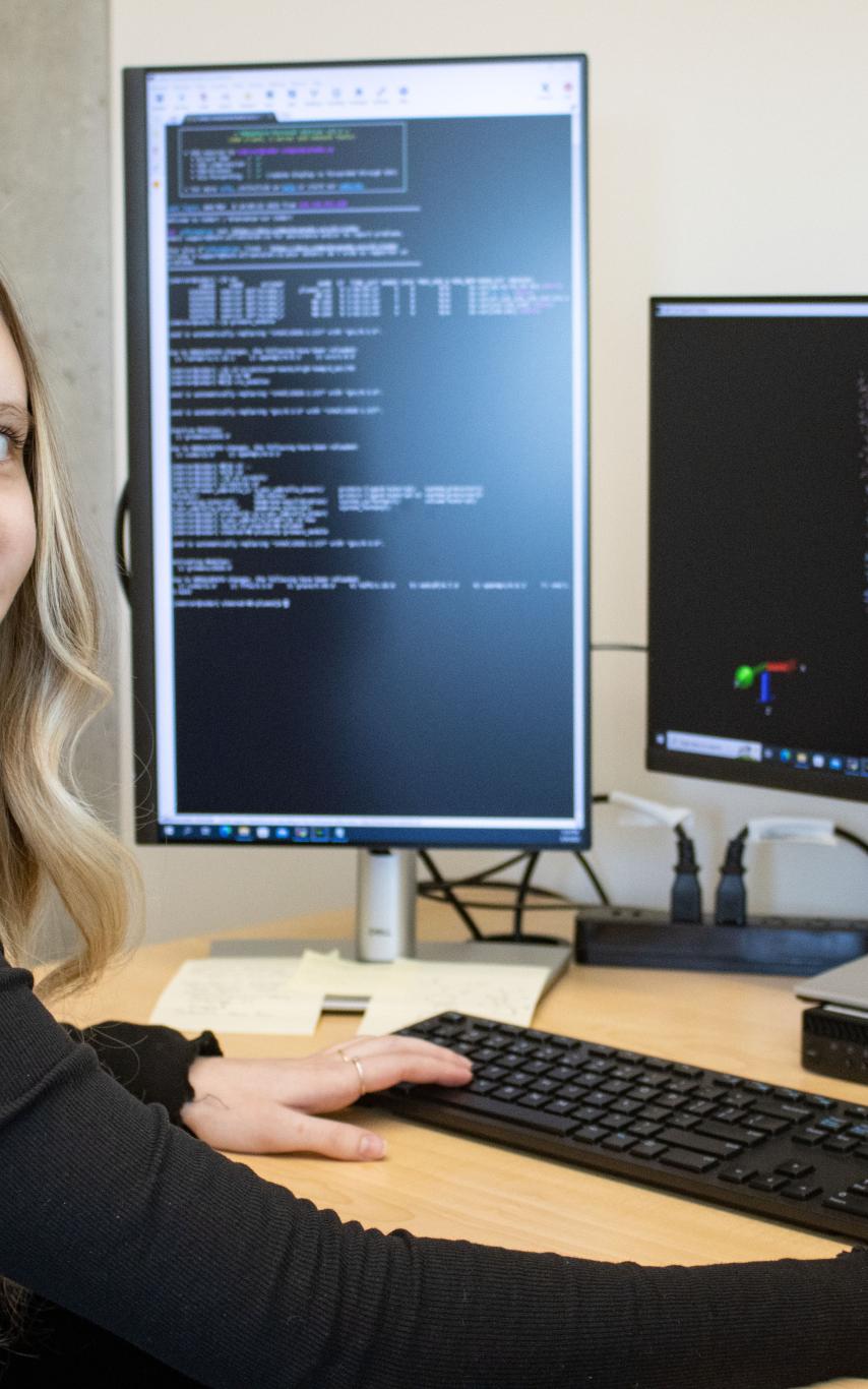 Savannah sits in front of her computer model